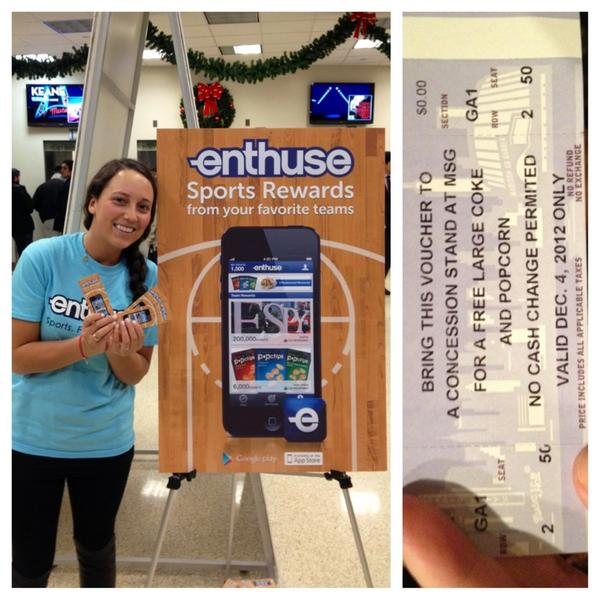 Enthuse sign and a staff member at a stadium concourse table